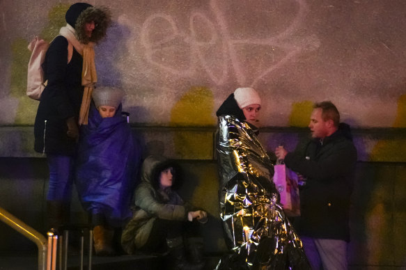 People wait near the building of Philosophical Faculty of Charles University in downtown Prague, Czech Republic.