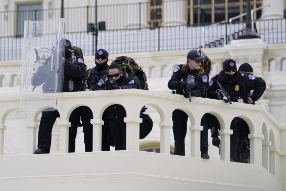 Police keep a watch as a mob loyal to then-president Donald Trump advance on the US Capitol on January 6 last year.