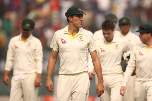 Pat Cummins leads the team off the ground after the loss to India on day three of the second Test.