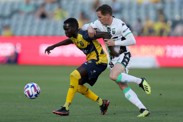 Central Coast’s Garang Kuol holds off Neil Kilkenny of Western United on Saturday in Gosford.