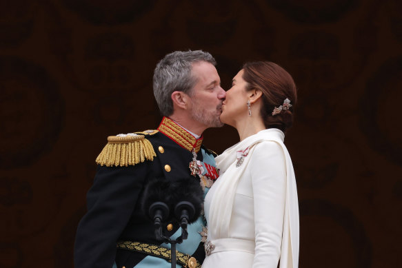 Danish King Frederik X and Queen Mary kiss on the balcony of Christiansborg Palace.