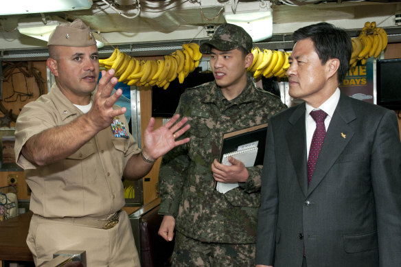 Former US Navy submarine commander Noel Gonzalez (left) giving a tour of nuclear-powered submarine USS Cheyenne.
