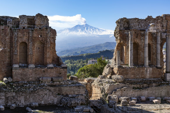 Through the ruins to a smoking Mount Etna.