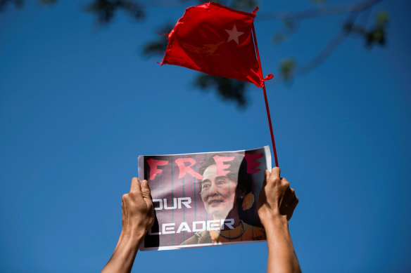 A demonstrator holds up a placard outside the Central Bank of Myanmar to protest against the military coup and to demand the release of elected leader Aung San Suu Kyi, in Yangon.