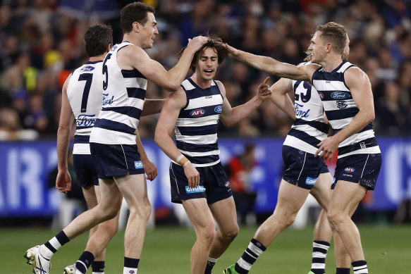 Gryan Miers and the Cats celebrate a goal.