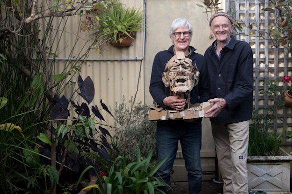 Rod Holdaway (left) holds a bust he created of Merrick Fry (right).