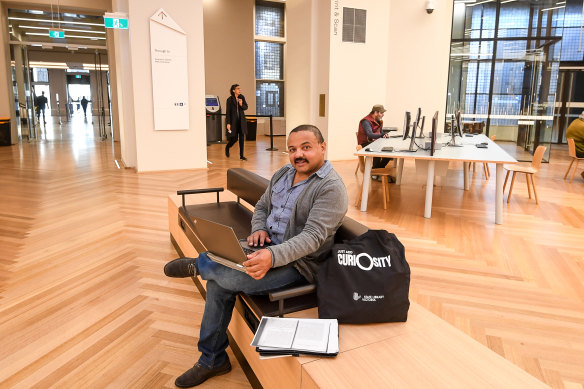 Just like home: State Library of Victoria regular Michael Monty is happy it's re-opened.