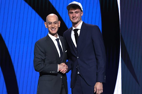 Cooper Flagg (right) shakes hands with NBA commissioner Adam Silver after being drafted first overall by the Dallas Mavericks.