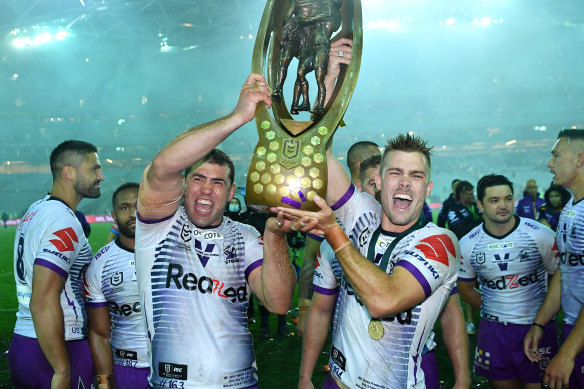 Ryan Papenhuyzen and Dale Finucane with the NRL trophy in 2020.