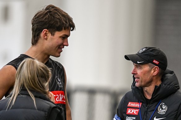 Collingwood coach Craig McRae (right) talks to Charlie West on Tuesday.