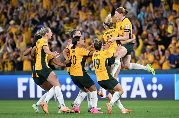 Cortnee VIne (right) leaps on her teammates to celebrate.