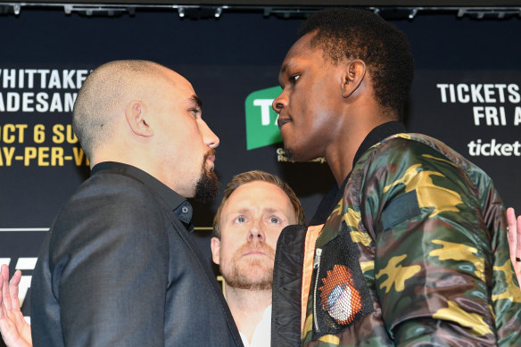 Israel Adesanya faces off with Robert Whittaker.
