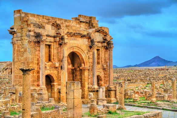 Arch of Trajan located within the extensive Roman ruins of Timgad in Algeria. 