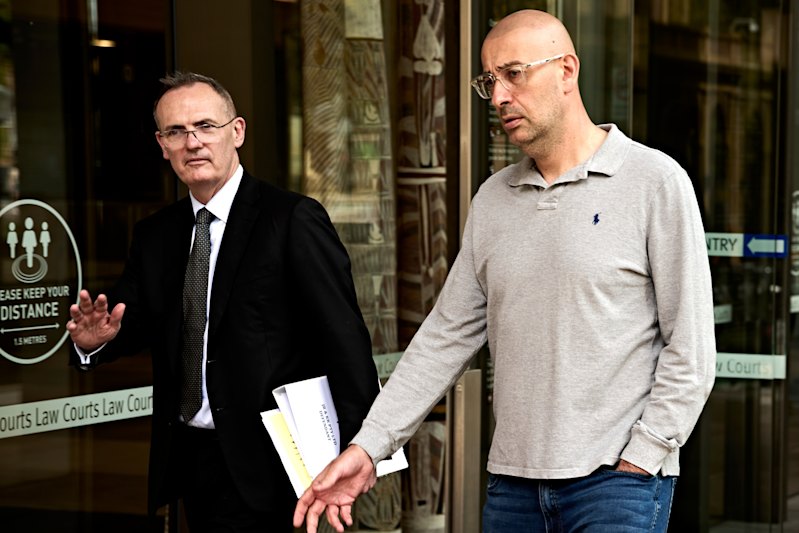 Former Virtical director Mark Toma (right) walking out of the Federal Court after his examination last March.