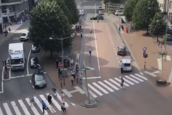 People run in the street after hearing gunshots in Liege, Belgium.