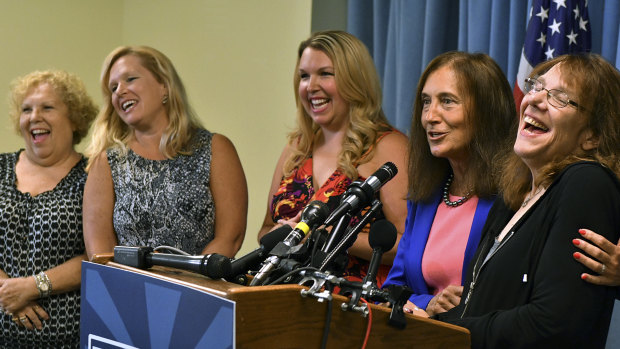 A winner exposed: Mavis Wanczyk, right, of Chicopee, Massachusetts., laughs beside state treasurer Deb Goldberg during a news conference where she claimed the $US758.7 million Powerball prize at Massachusetts State Lottery headquarters in August 2017, in Braintree, Massachusetts. 