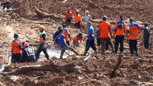 Rescuers search the site of the landslide in central Java on Friday.