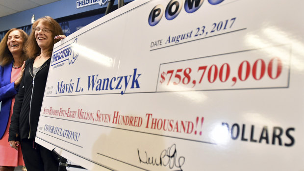 A Powerball lottery winner and her cheque in Massachusetts in August 2017.