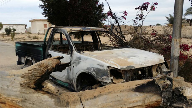 A burned truck is seen outside Al-Rawda Mosque in Sinai, Egypt a day after attackers killed hundreds of worshippers in November, 2017.