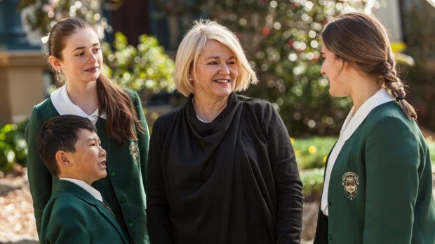 Santa Sabina College principal Dr Maree Herrett, with students wearing the soon-to-be-discontinued uniforms in 2016.