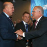 Prime Minister Scott Morrison pauses to shake hands with Home Affairs Peter Dutton at the QLD LNP convention.