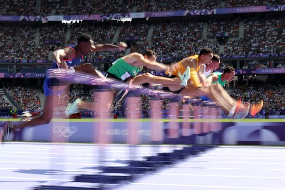 Athletes compete in the Men’s 110m hurdles repechage.