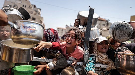 A charity distributes meals to Palestinians facing food shortages amid ongoing Israeli attacks and severe restrictions in Gaza on July 28.