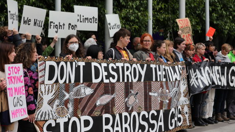Protesters gather at the front of the Federal Court in Melbourne during the Santos appeal last month.