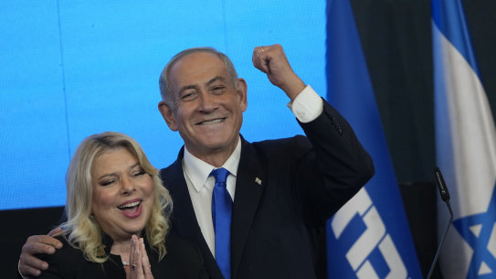 Former Israeli Prime Minister and the head of Likud party, Benjamin Netanyahu and his wife Sara gesture after first exit poll results for the Israeli Parliamentary election at his party’s headquarters in Jerusalem, on Wednesday.