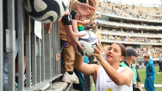 Matildas star Sam Kerr signs autographs in Perth.