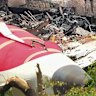 Investigative officials stand at the site of Air India Boeing 787 that crashed  on June 13. 