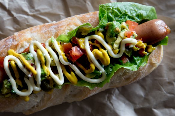 Hot dog with avocado and jalapeno.