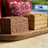 The 12-tier honey cake (right) and choc-caramel mikado with 10 layers at Armenian bakery Tatik’s Delights.