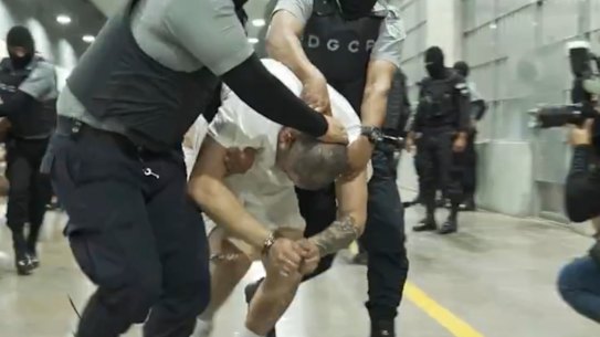 A man identified by Jennifer Vasquez Sura as her husband, Kilmar Abrego Garcia, is led by force by guards through the Terrorism Confinement Centre in Tecoluca, El Salvador in an undated photo.