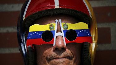 An anti-government protester wears Venezuelan flag motif sunglasses during a demonstration demanding the resignation of President Nicolas Maduro, in Caracas on  Saturday.