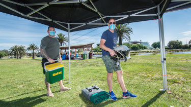Brod Helmers and Keith Elshout setting up for a big day at Footscray Park, opposite Flemington Racecourse.