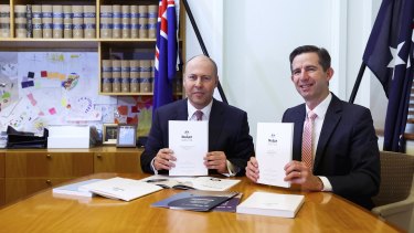 Treasurer Josh Frydenberg and Finance Minister Simon Birmingham with the 2021 budget papers at Parliament House on Tuesday.