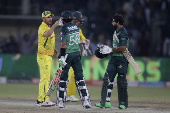 Babar Azam and Aaron Finch bump fists after the match.