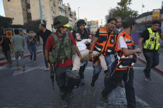 Israeli security forces and paramedics carry a wounded Jewish man after he was shot during violent unrest in Lod on Thursday.