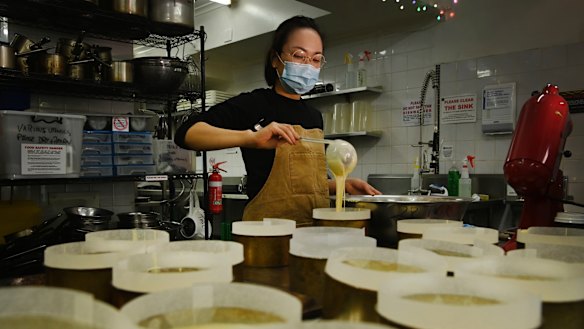 Naoka Kojo, co-creator of 15centimeters, prepares cheesecakes for baking. 
