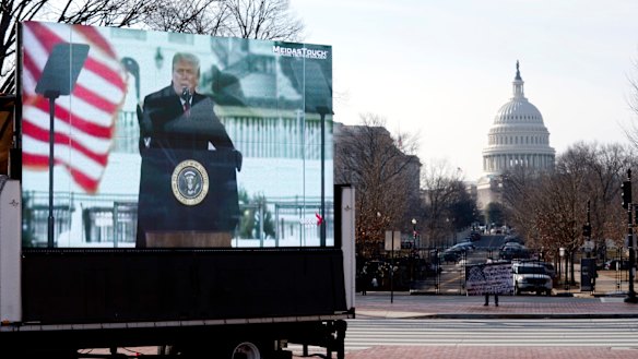 A photo of former President Donald Trump appears on a billboard truck parked near of the US Capitol during the impeachment trial.