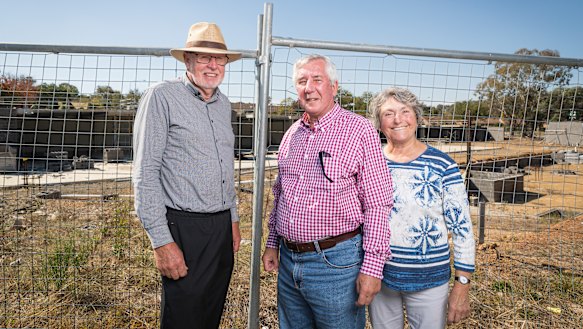 Giralang Residents Action Group members Bill Burmester and Ross and Olga Calvert, at the site of the old Giralang shops in April.