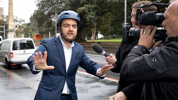 Sam Dastyari arrives on a Lime bike to give evidence at the inquiry into alleged illegal donations to the Labor Party.