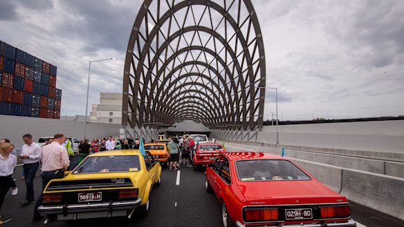 Vintage and classic cars line up before passing through the tunnel on Saturday.