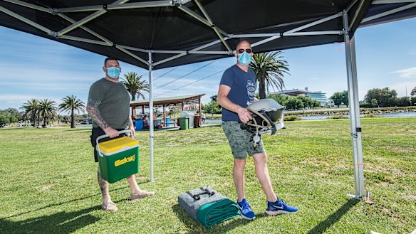 Brod Helmers and Keith Elshout setting up for a big day at Footscray Park, opposite Flemington Racecourse.