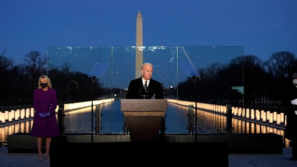 President-elect Joe Biden speaks during a COVID-19 memorial, with lights placed around the Lincoln Memorial Reflecting Pool. 