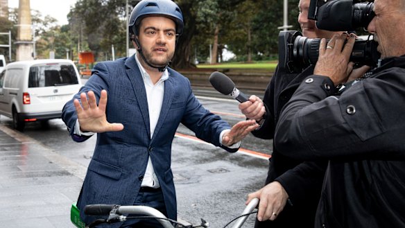 Sam Dastyari arrives on a lime bike to give evidence at the ICAC inquiry into alleged illegal donations to the Labor Party.