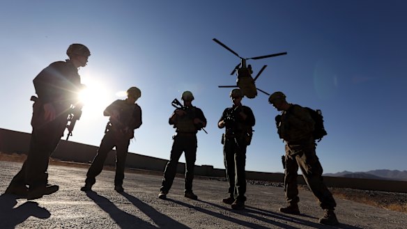 American soldiers wait on the tarmac in Logar province, Afghanistan.
