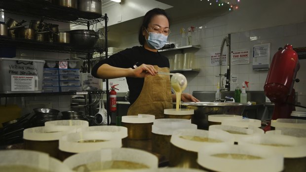 Naoka Kojo, co-creator of 15centimeters, prepares cheesecakes for baking. 