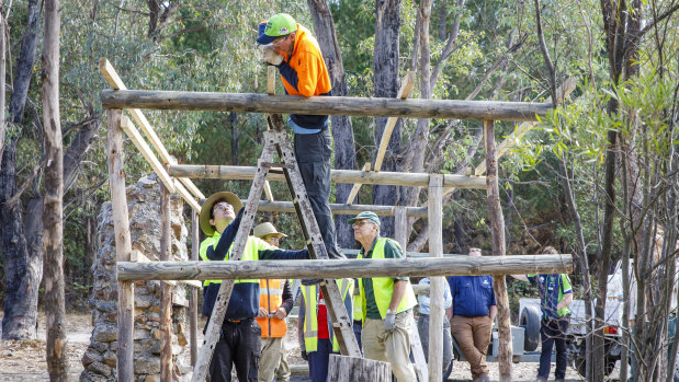 ACT Parks and Conservation staff work with volunteers to restore Tidbinbilla Hut, a site used for decades as a camping and picnic area before it fell into disrepair.